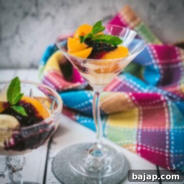 Elegant peach melba, served in cocktail glass.