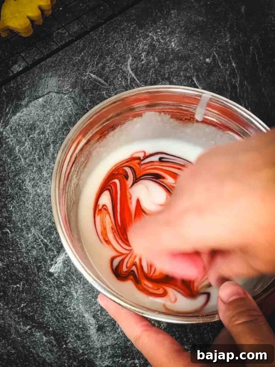 Raspberry Swirl Autumn Leaf Cookies 12 Gently swirling orange food coloring into the white glaze with a toothpick to create a beautiful marbled effect.