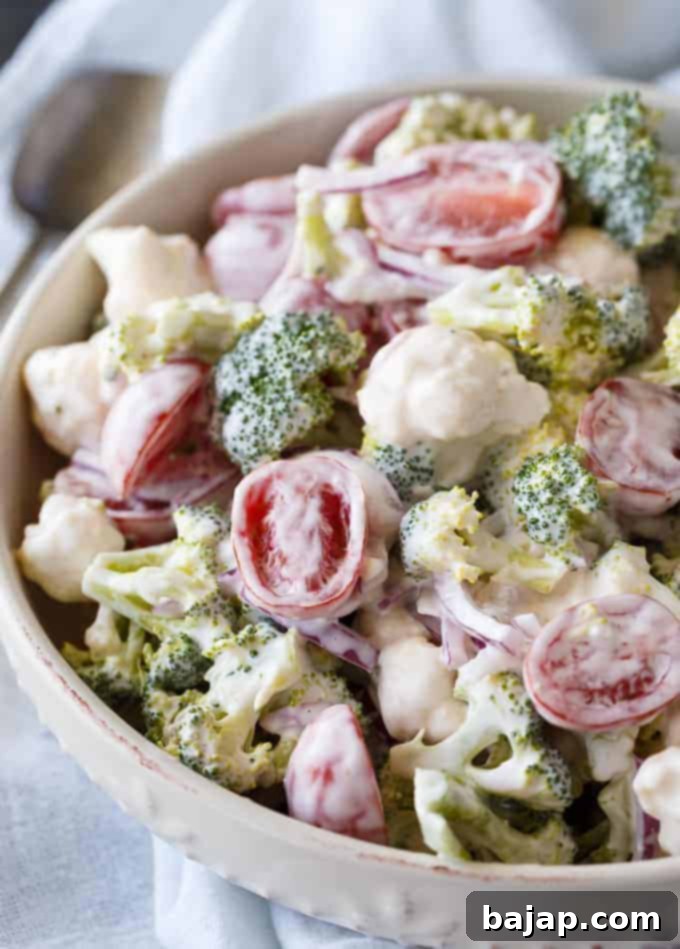 Fresh Christmas Salad with broccoli, cauliflower, red onion, and cherry tomatoes