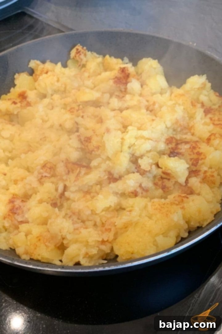 Close-up of crispy Austrian Erdäpfelschmarrn cooking in a pan