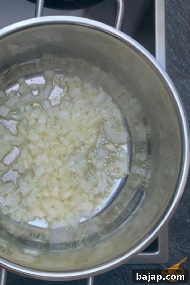 Gluten-Free Sweet Corn Soup 3 Heat the butter in a cooking pot and sauté the chopped onion until translucent and fragrant.