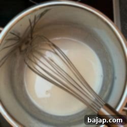 Cooking the Tangzhong pre-dough mixture in a small pot.