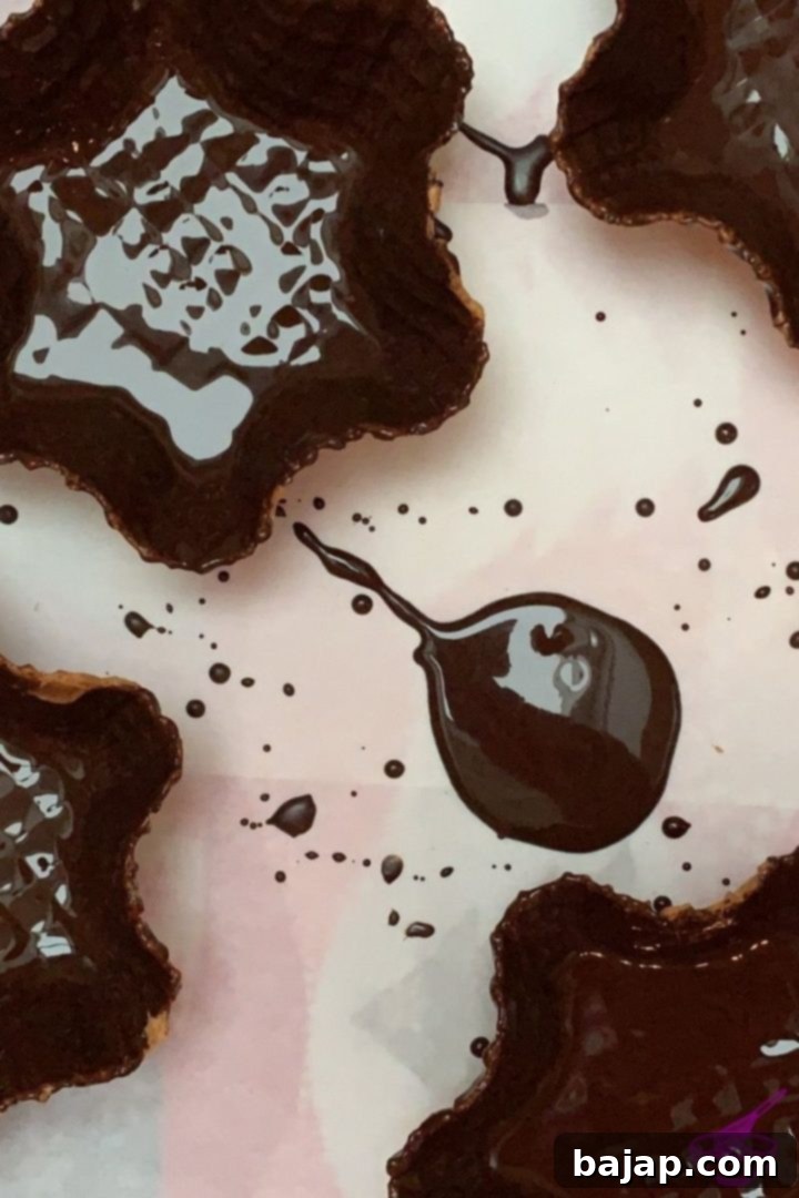 Inside of a waffle blossom coated with dark chocolate, ready for chestnut purée.