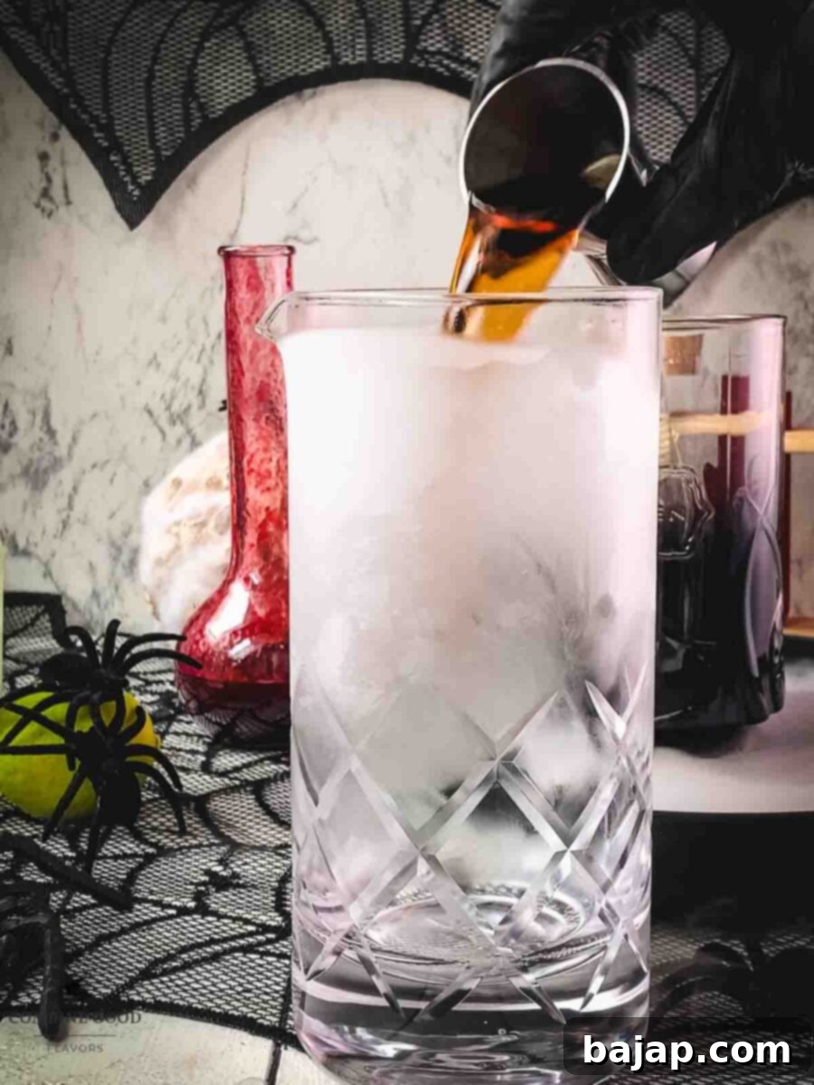 Pour Kraken spiced rum into the chilled stirring glass.