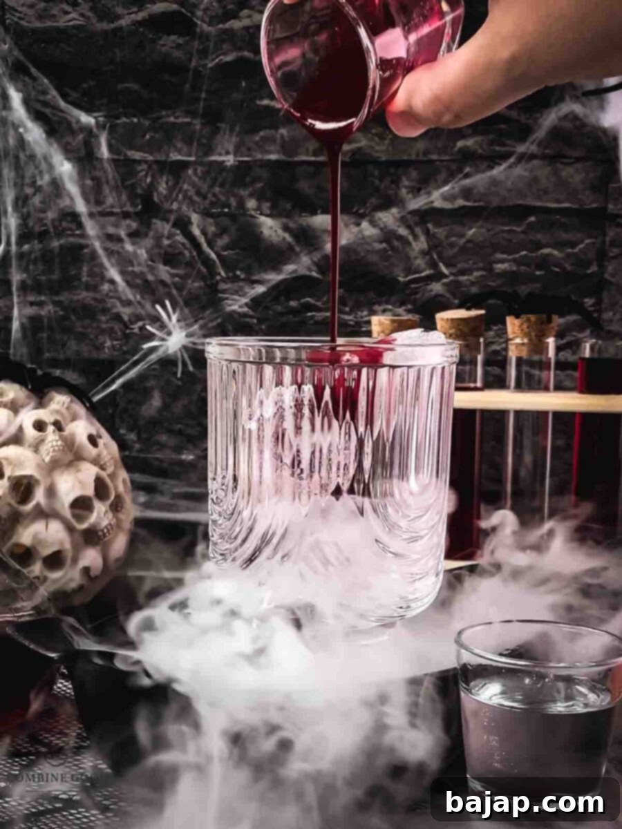 Step 1: Berry Blood Syrup is poured into a tall glass over ice.