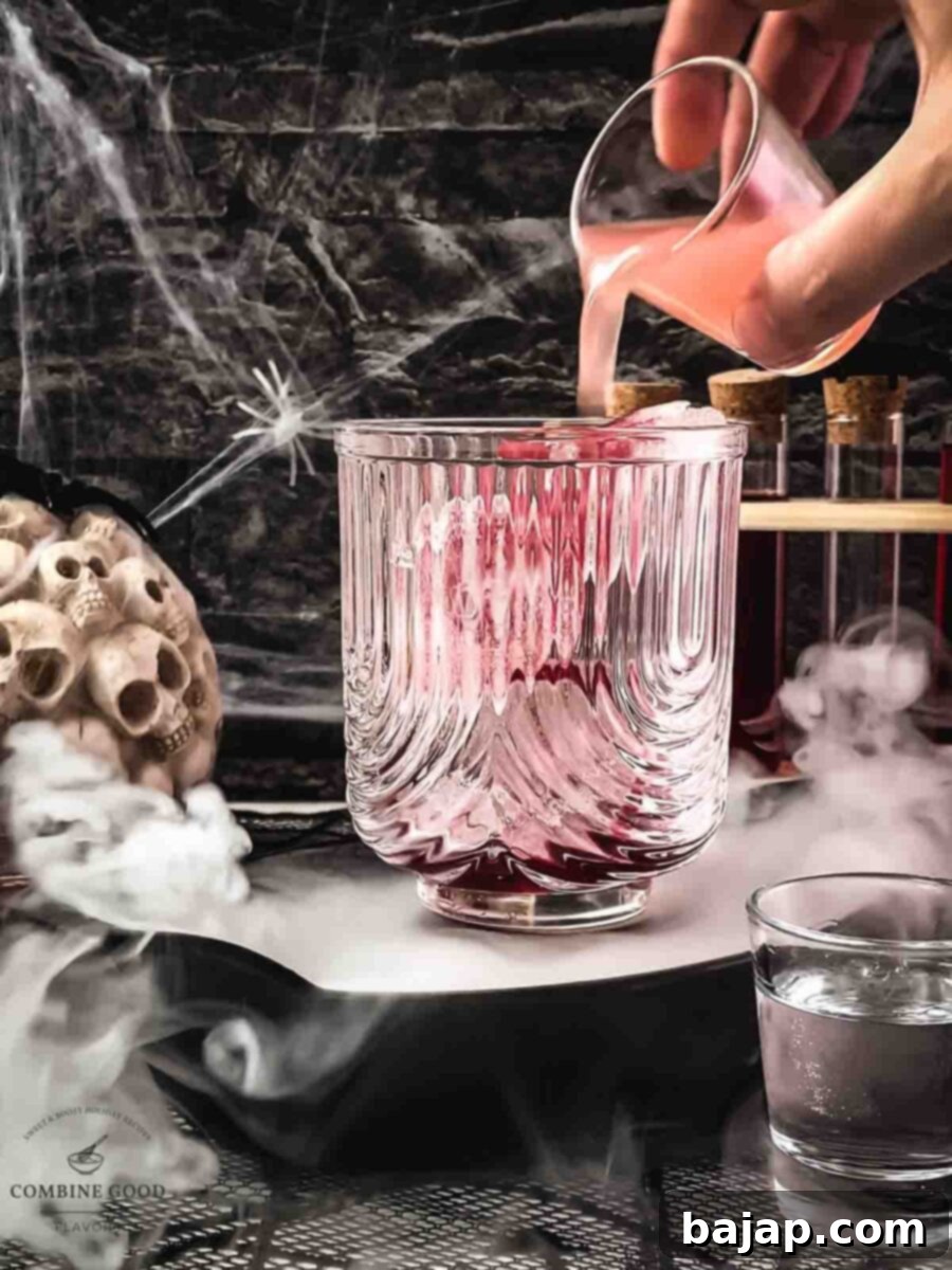 Step 2: Vodka is poured into the glass, layering above the syrup.