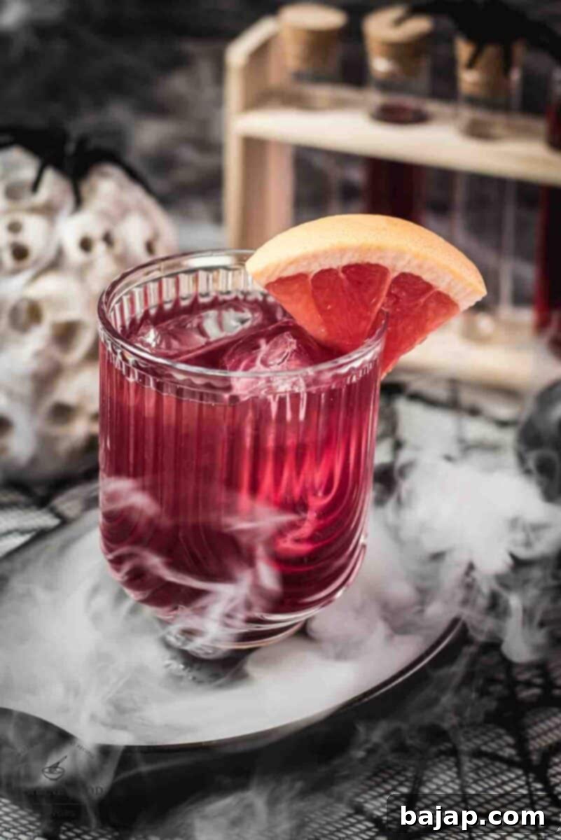 A finished Bloody Sea Breeze cocktail, beautifully layered, garnished with a grapefruit slice, ready to be served.