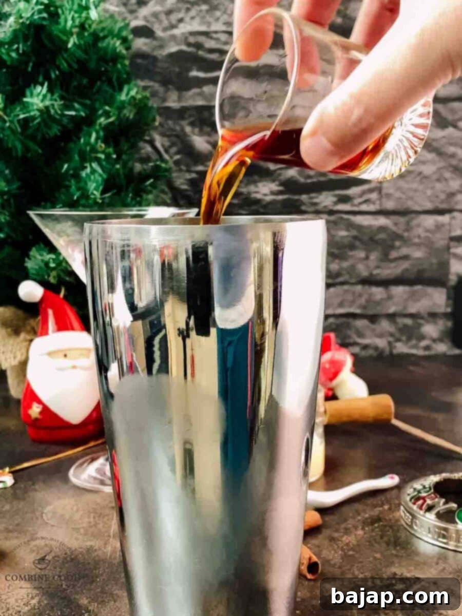 Holiday Nog Dream 5 Adding spiced rum to the cocktail shaker, infusing the drink with warm holiday flavors.