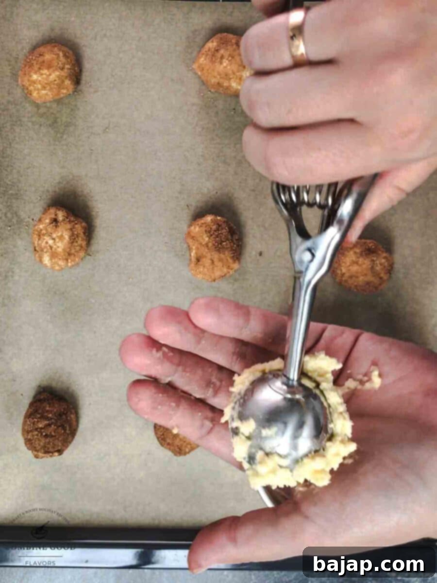 Place the dough ball into your hand and roll it between your hands to form a cookie ball.