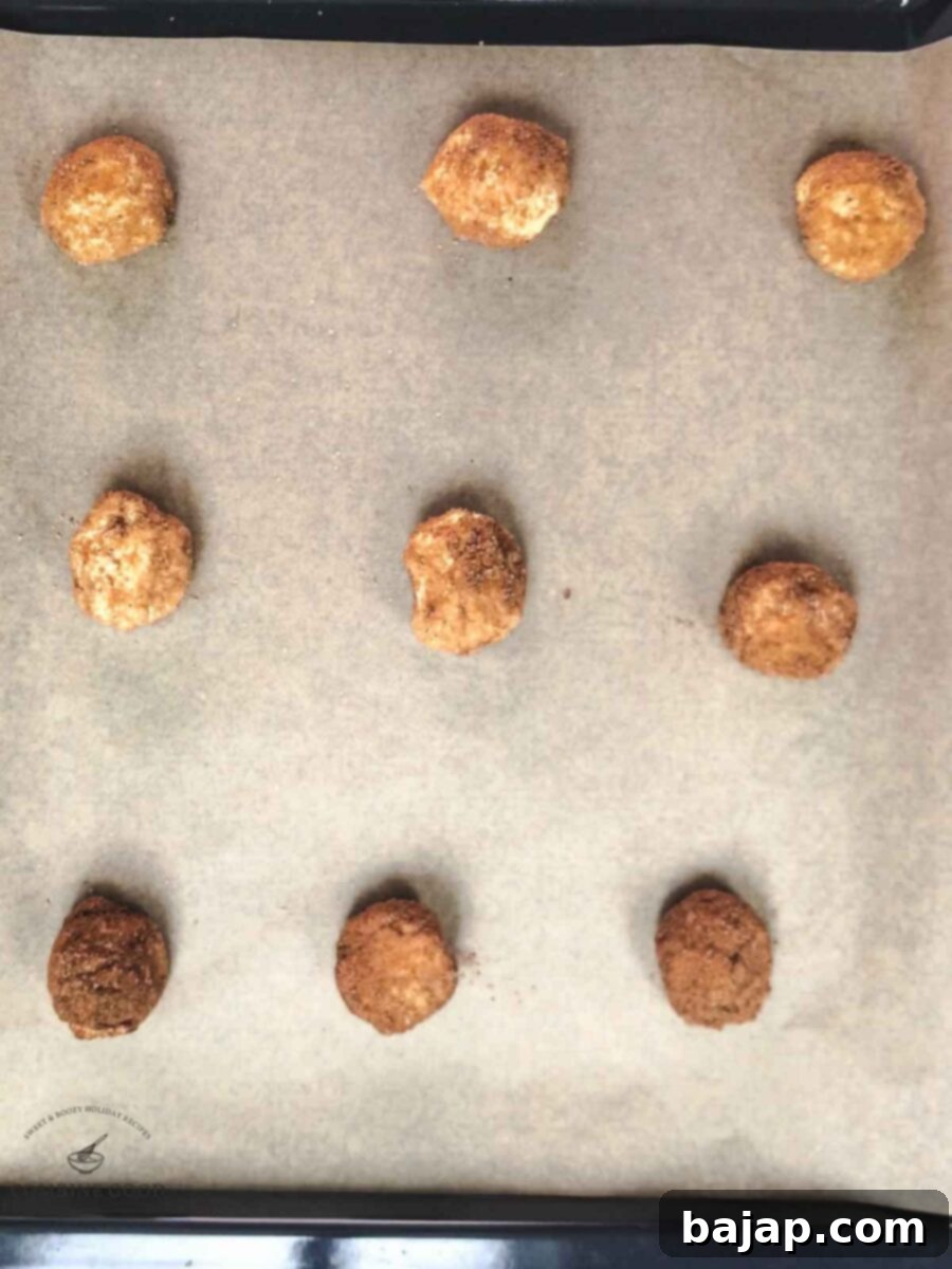 Place the coated cookie dough balls on a baking sheet lined with parchment paper.