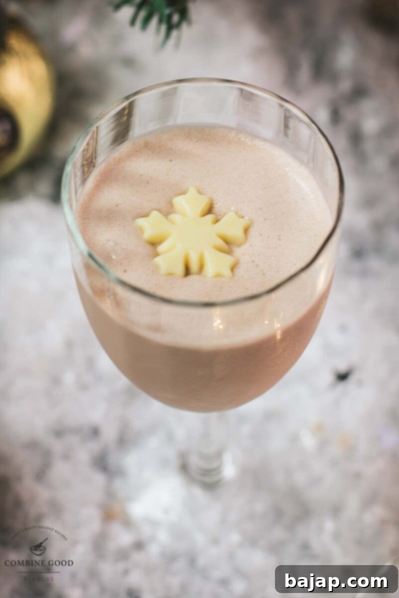 Delicious Rum Alexander cocktail, adorned with a white chocolate snowflake garnish.