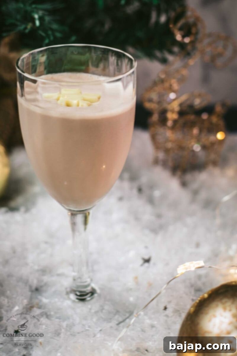 Delicious Rum Alexander cocktail, garnished with a white chocolate snowflake.