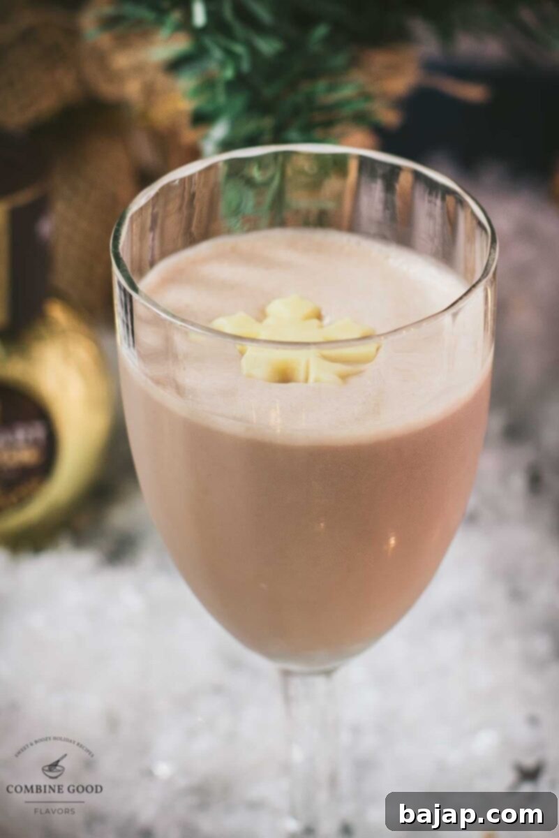 Divine Rum Alexander cocktail, garnished with a white chocolate snowflake.