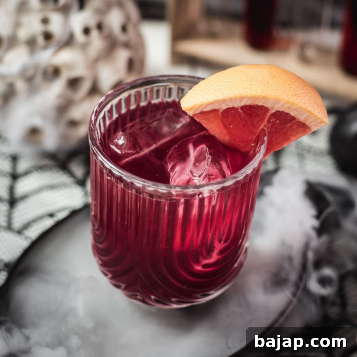 Spooky bloody sea breeze cocktail, served in a beautiful glass. Placed in a smoking black bowl.