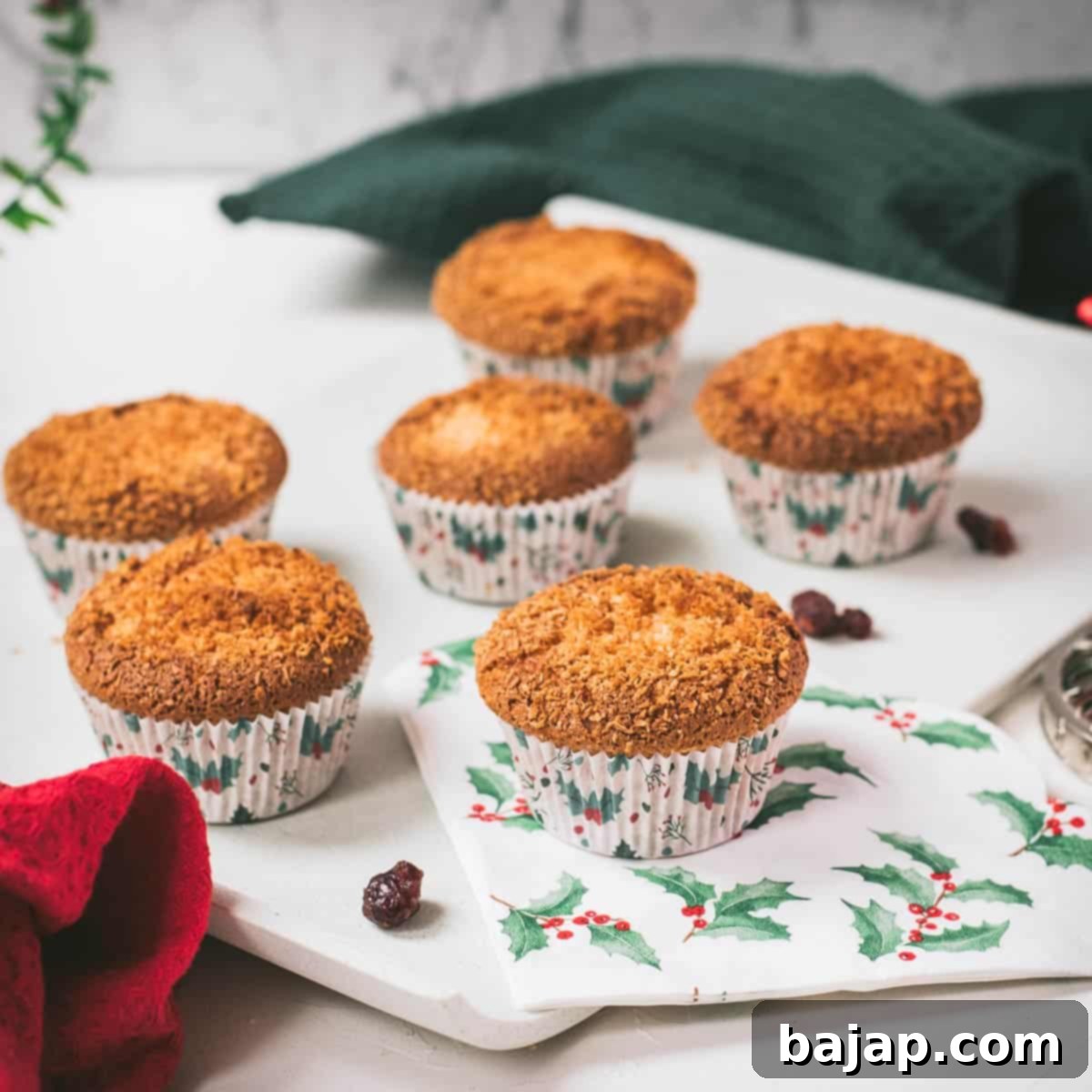 Cute egg yolk cranberry coconut muffins in Christmas styled muffin liners, perfect for holiday gatherings.