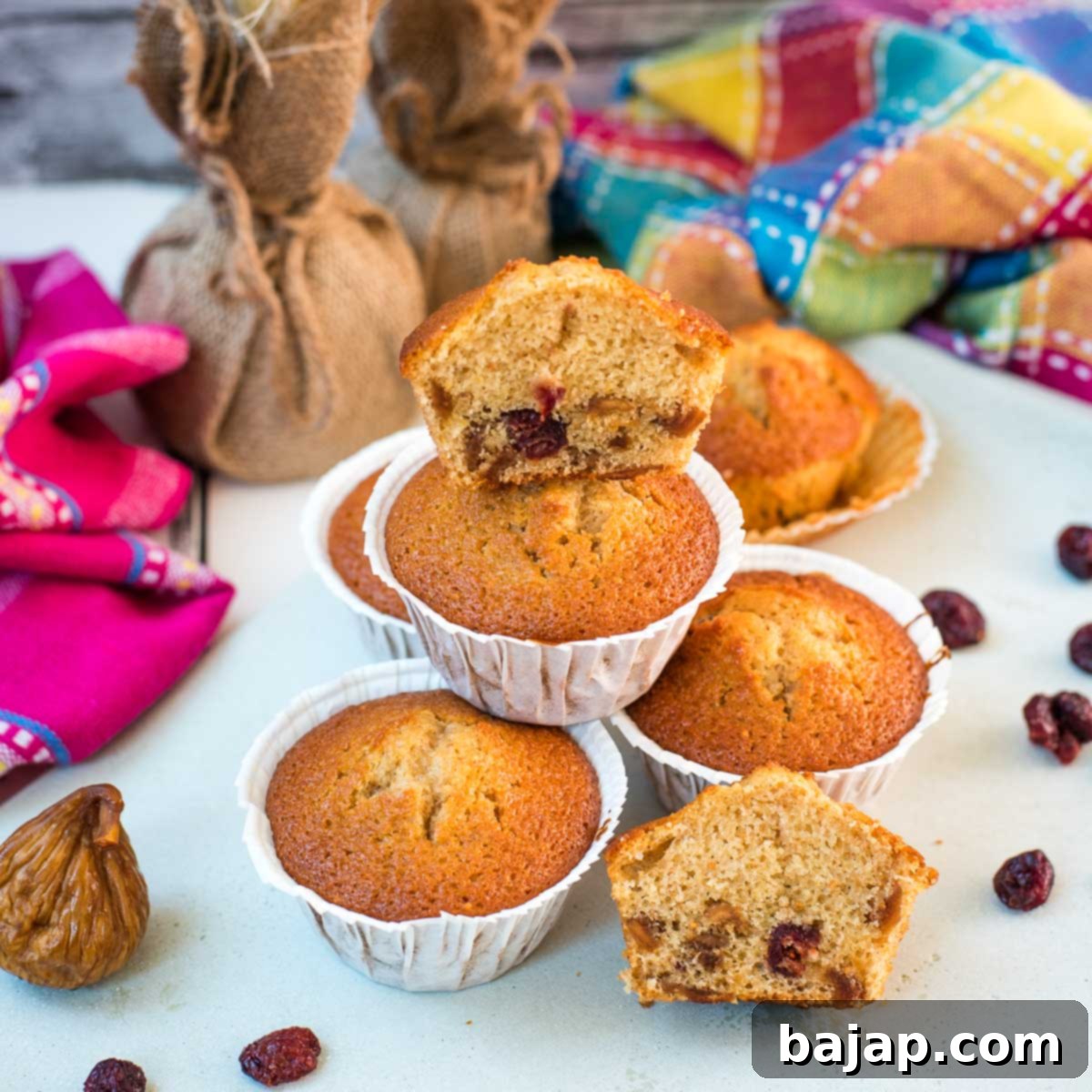Delicious, and very easy to make, fruit cake muffins, filled with dried figs and dried cranberries. Placed on white plate.