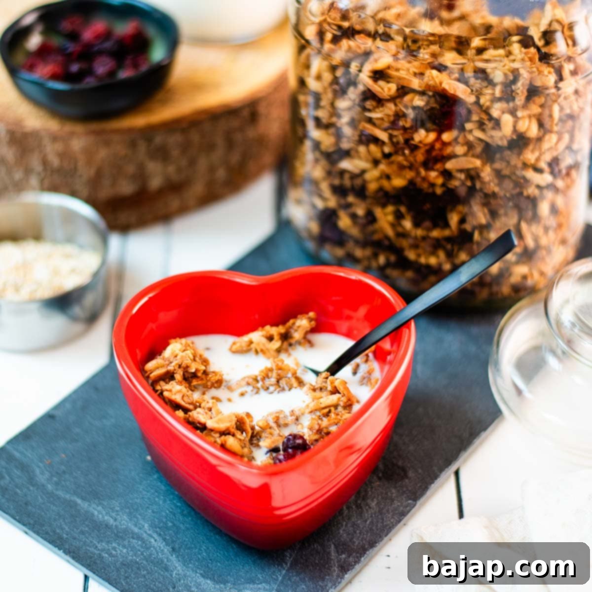 Gorgeous heart shaped breakfast bowl, filled with delicious maple cinnamon granola with milk.