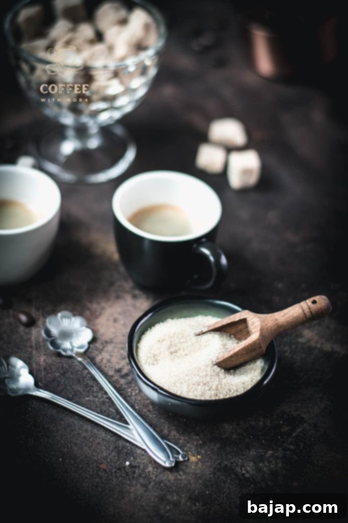 Brown Sugar Coffee Bliss: A Sweet Twist on Your Morning Brew 1 Brown sugar in a dark green bowl next to a black cup filled with black coffee.