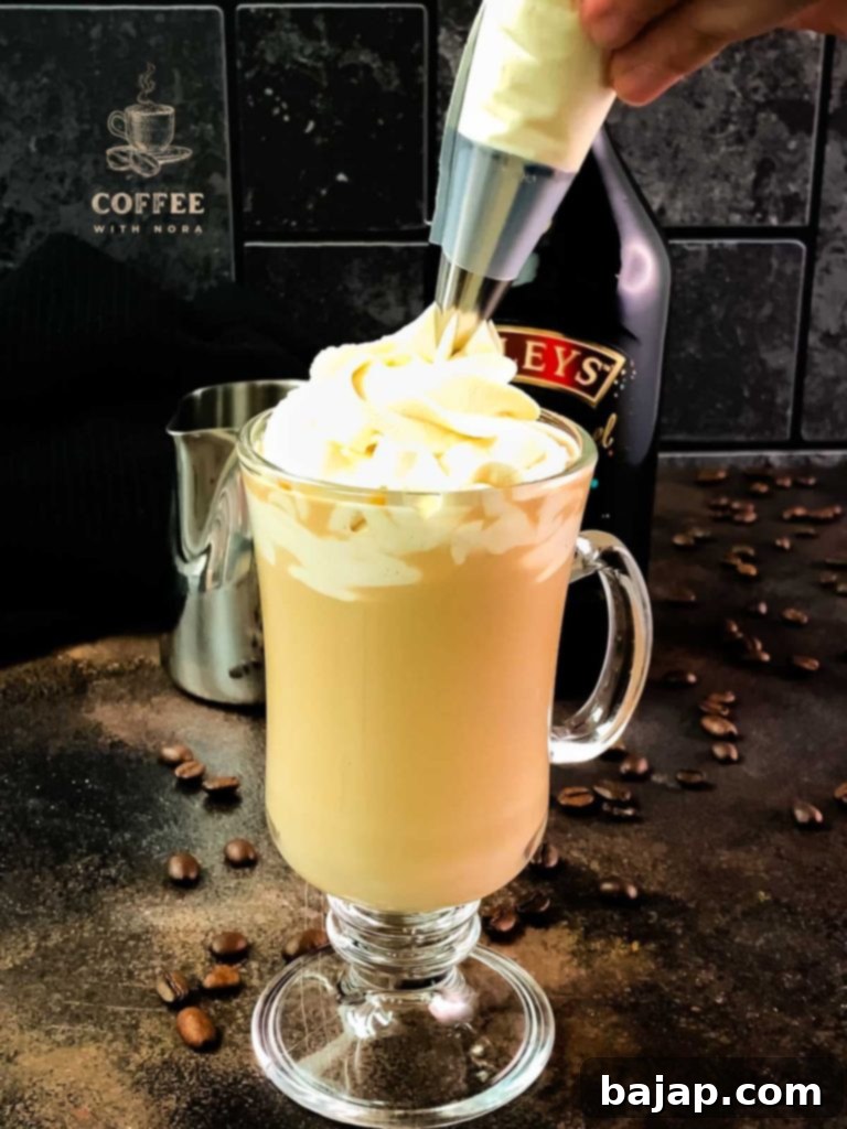 Elegantly Infused: A Baileys Coffee Creation 5 Topping the Baileys and coffee with whipped cream.