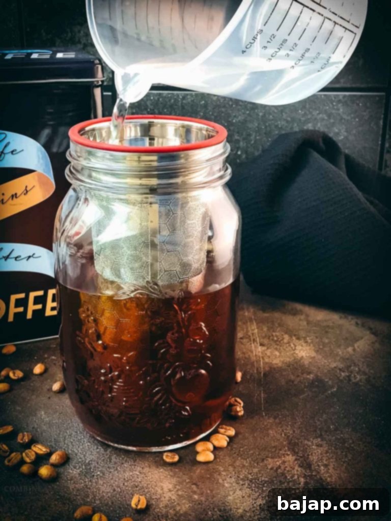 Mason Jar Cold Brew Delight 4 Filtered water being poured into a mason jar.