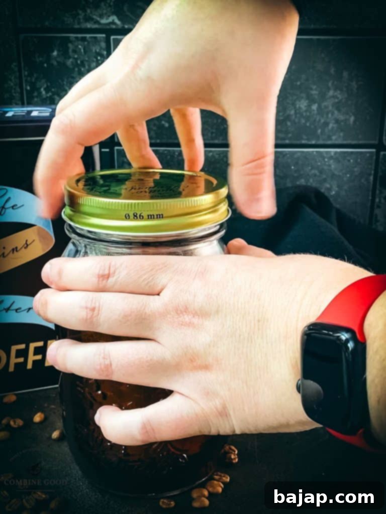 Mason Jar Cold Brew Delight 5 A mason jar being sealed before refrigeration.
