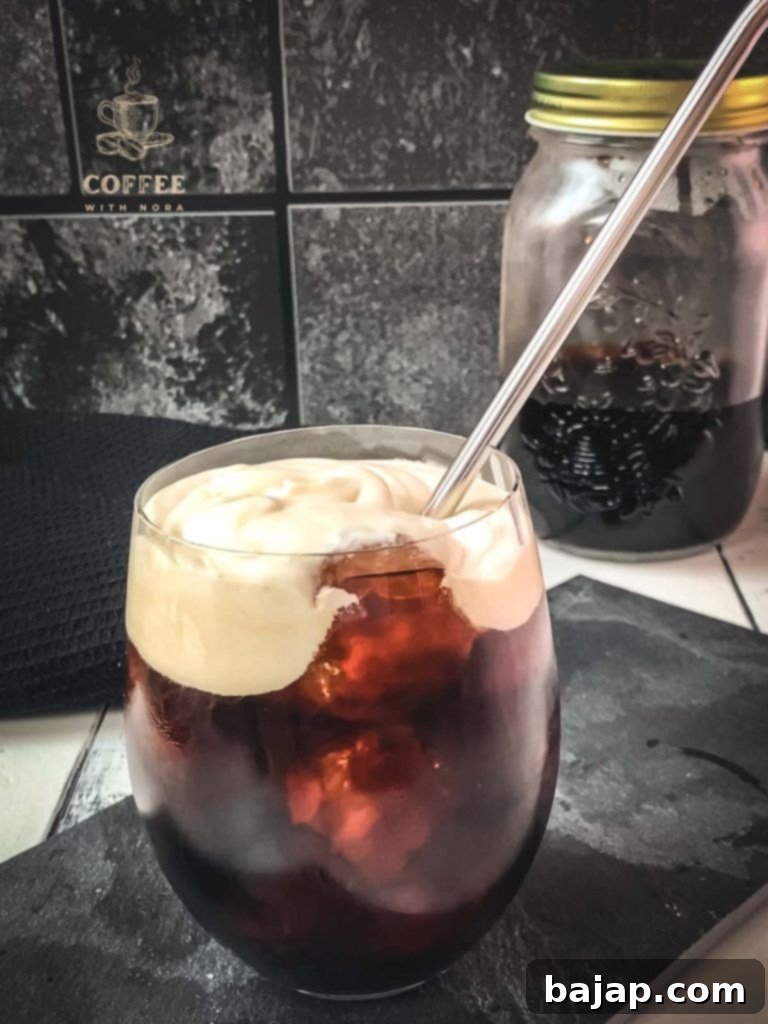 Iced Vanilla Cream Coffee: A Refreshing Homemade Brew 10 Placing a metal straw into the vanilla sweet cream cold brew.