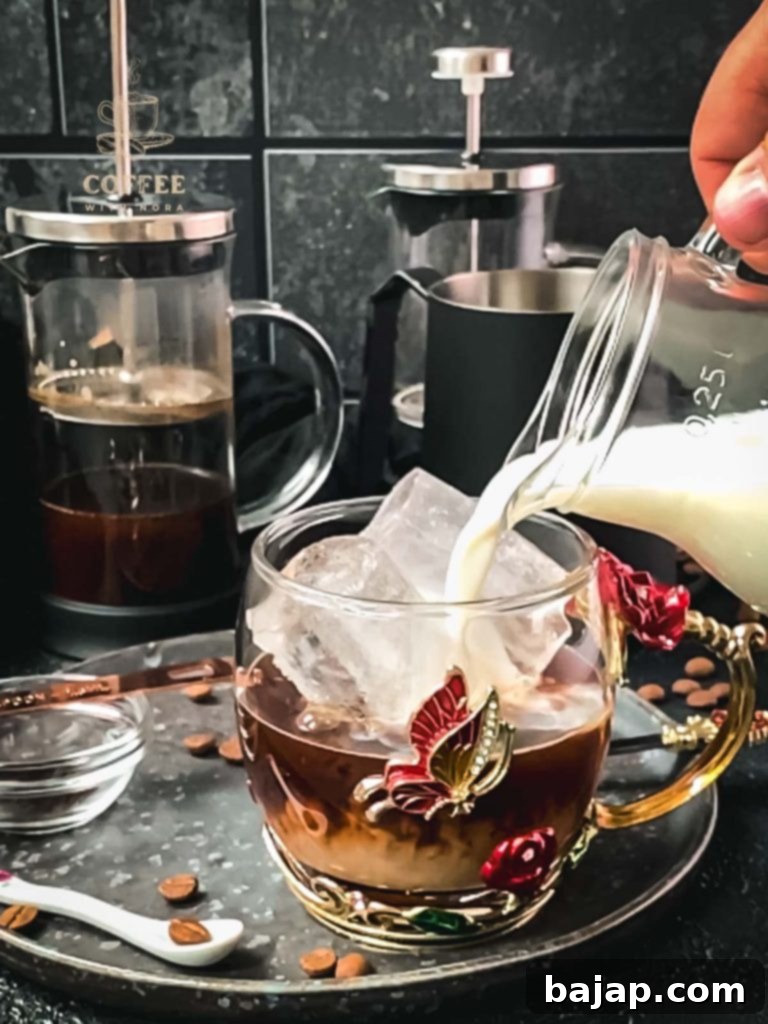 Vanilla Bean Bliss: French Press Iced Coffee 7 Adding cold milk to the vanilla French press coffee.