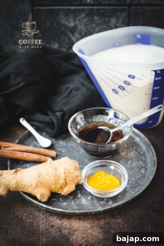 Spiced milk ingredients: almond milk, turmeric, ginger, cinnamon, and maple syrup.