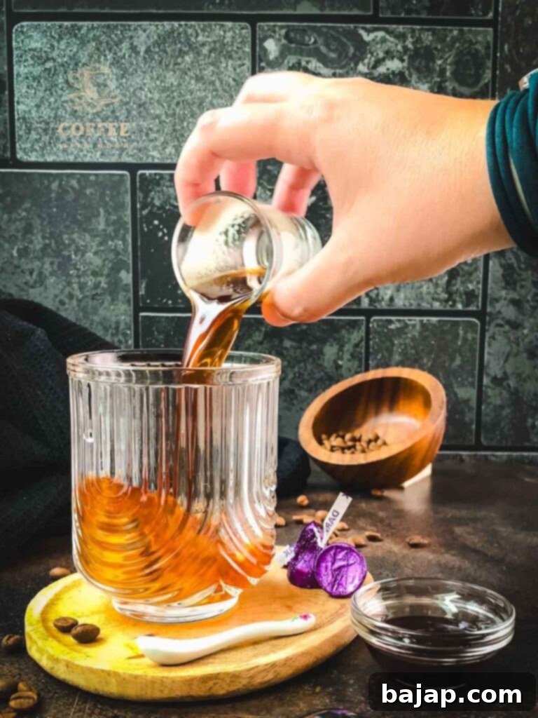 Pouring espresso into a serving glass.