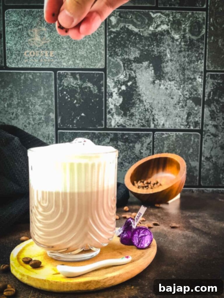 Sprinkling the mocha with chocolate sprinkles.