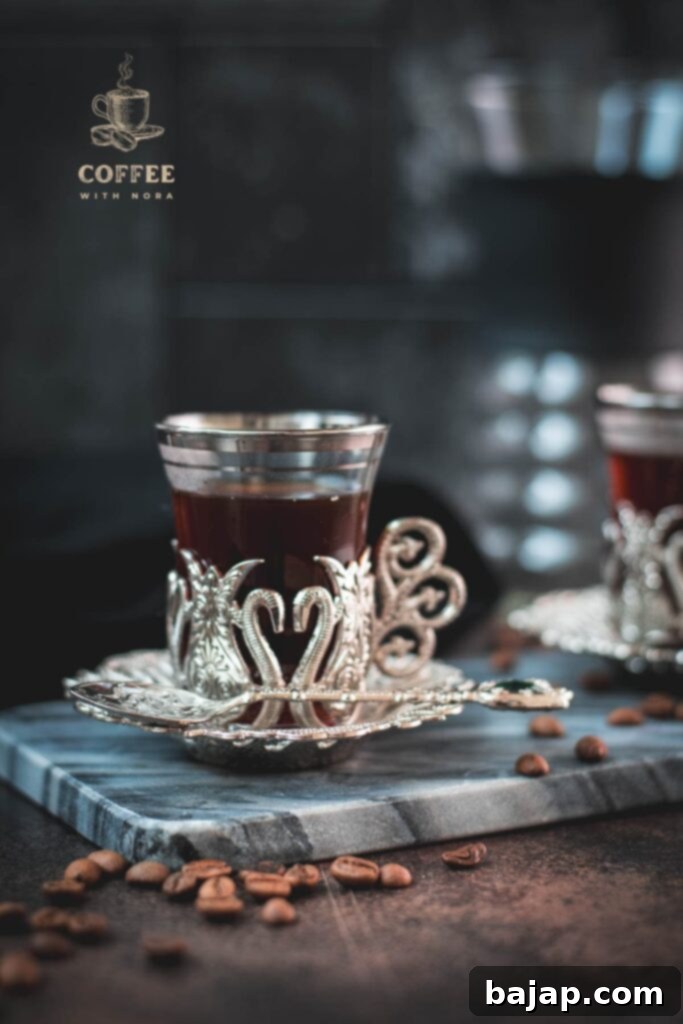 V60 Pour-Over: The Art of the Perfect Cup 1 Pour over coffee in a glass cup on a marbled plate.