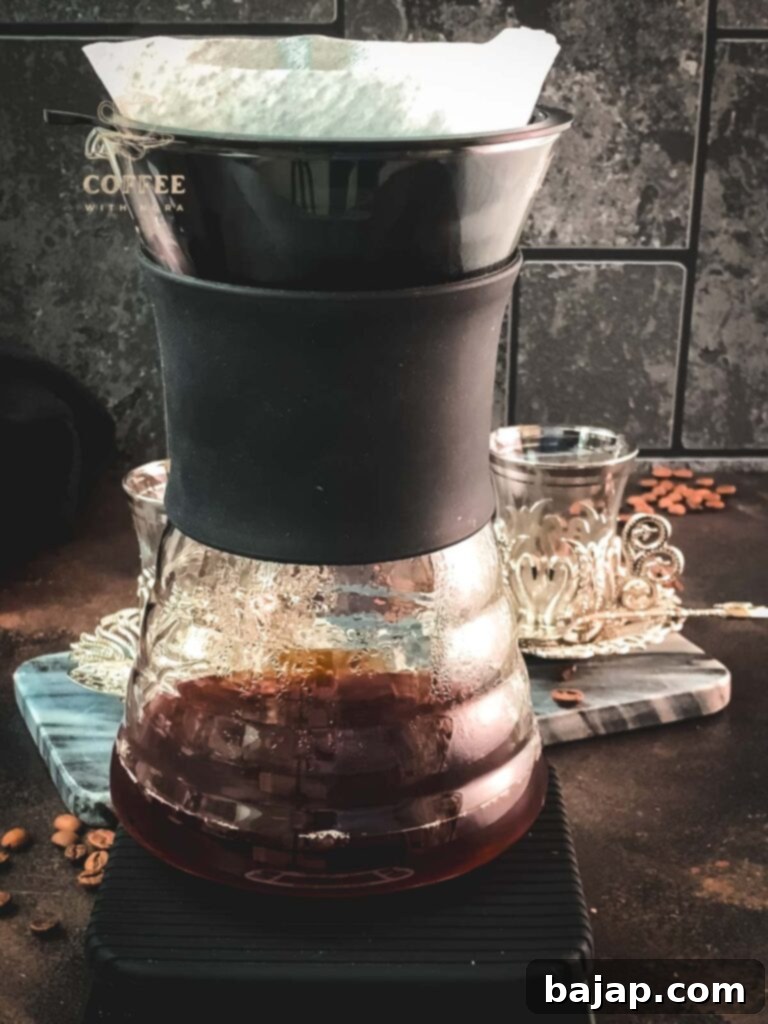 V60 Pour-Over: The Art of the Perfect Cup 7 Hario V60 coffee dripper on a coffee scale during the pouring process.