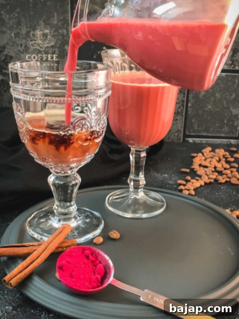 Topping the coffee with creamy pink milk.