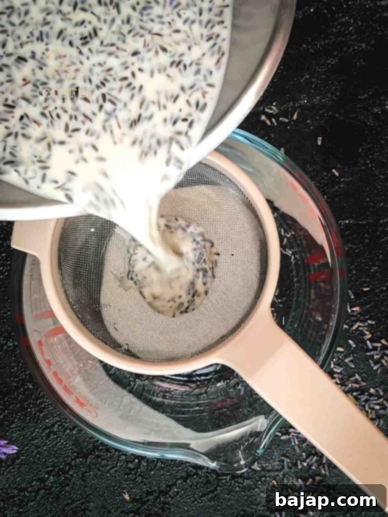 Pouring lavender heavy cream mix through a sieve