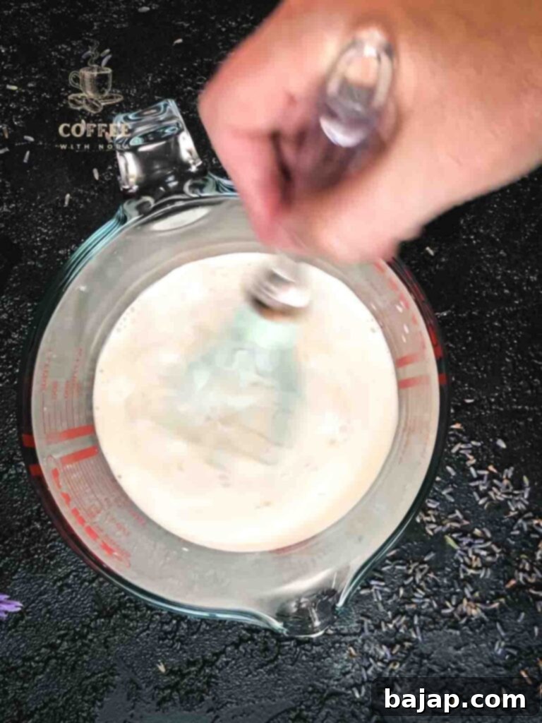 Mixing lavender syrup and vanilla extract with the lavender heavy cream mix