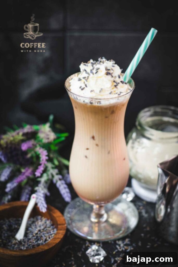 Lavender Dream Iced Latte 1 Iced Lavender Latte in Hurricane Glass with Whipped Cream and Lavender Buds