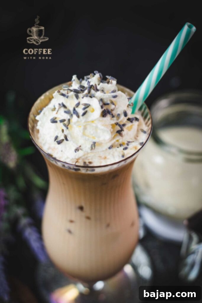 Lavender Dream Iced Latte 8 Iced Lavender Latte in Hurricane Glass with Whipped Cream and Lavender Buds served with a Straw