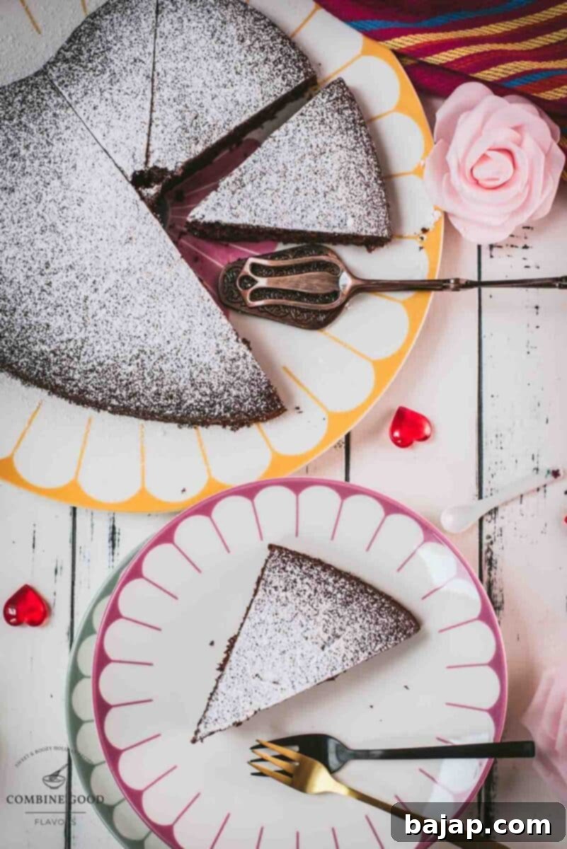 Effortless Valentine's Chocolate Cake 2 Delicious heart-shaped chocolate cake, dusted with powdered sugar. Ideal for Valentine's day! Placed on yellow-white serving plate.