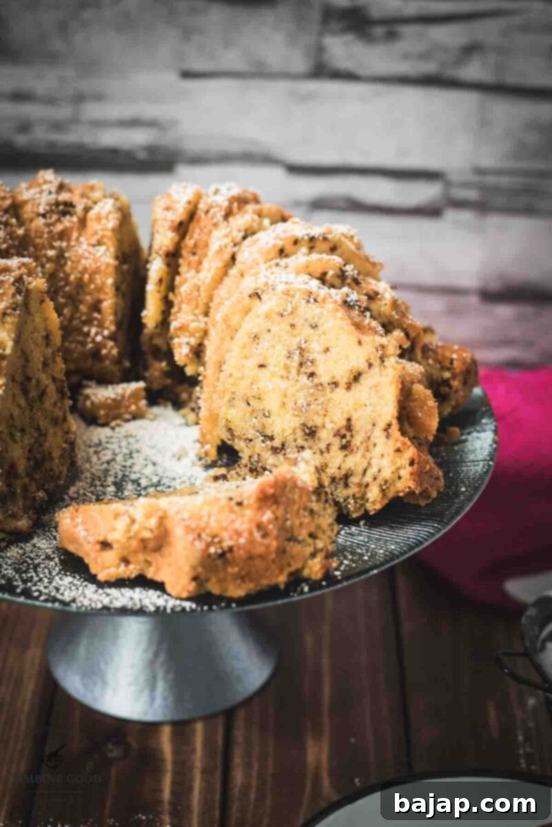 Vanilla Bean Bundt Cake with Dark Chocolate Drizzle 2 Delicious vanilla bundt cake with chocolate sprinkles, served on light blue cake stand.